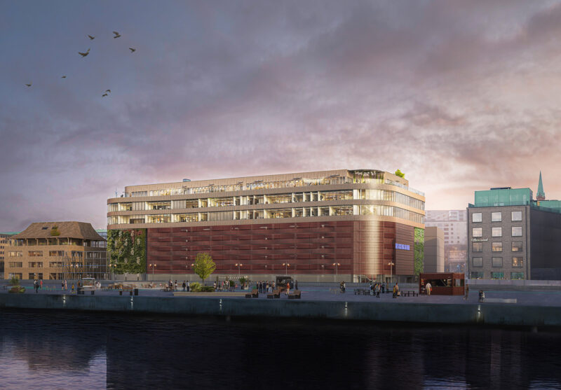 Kvällsbild på ett stort hus nära vatten